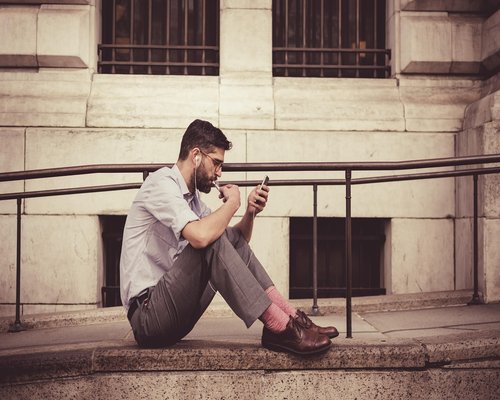 Close up of a person adjusting the brightness setting on a modern smartphone